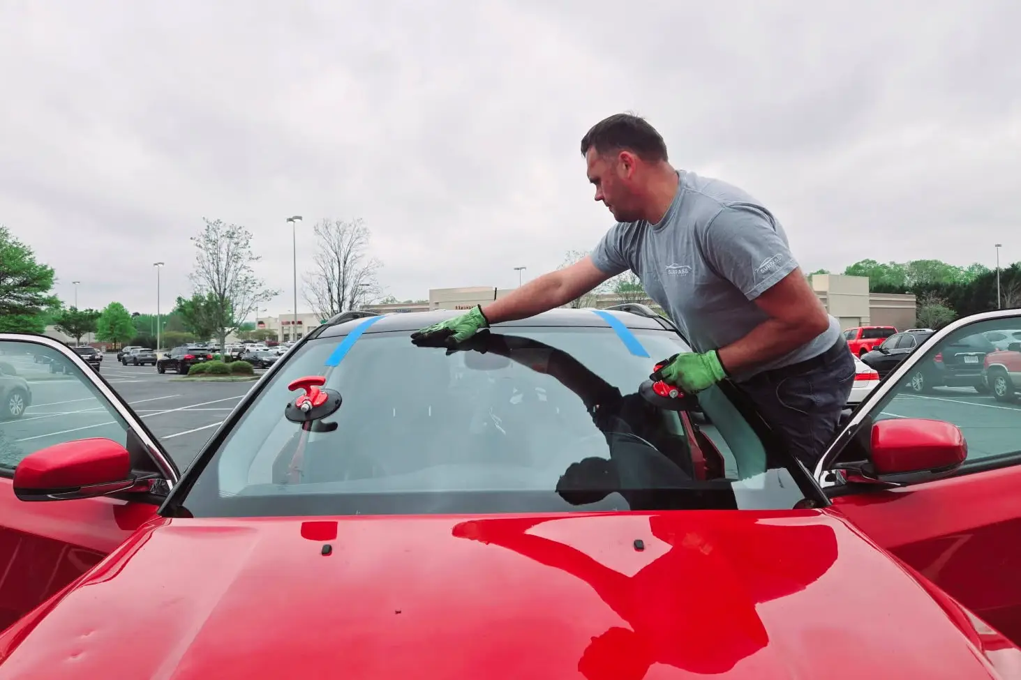 Professional auto glass repair service replacing a windshield